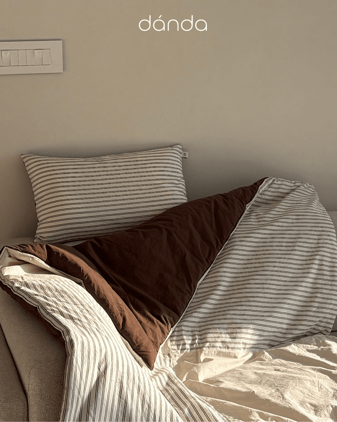 Cozy aesthetic shot of striped bedding and throws